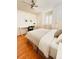 Cozy bedroom featuring natural light, a ceiling fan, and a workspace with white desk at 1829 Cypress Point Ln, Sarasota, FL 34234