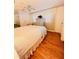 Bright bedroom featuring hardwood floors, shuttered windows, and a ceiling fan at 1829 Cypress Point Ln, Sarasota, FL 34234