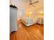 Cozy bedroom with hardwood floors, shuttered windows, and neutral decor at 1829 Cypress Point Ln, Sarasota, FL 34234