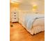 Inviting bedroom with a plush bed, ambient lighting, and hardwood floors at 1829 Cypress Point Ln, Sarasota, FL 34234