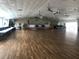 Spacious clubhouse interior featuring a stage, tables, and chairs, ideal for community events and gatherings at 1829 Cypress Point Ln, Sarasota, FL 34234