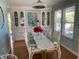 Charming dining room with a glass table, white chairs, and built-in display cabinets at 1829 Cypress Point Ln, Sarasota, FL 34234