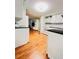 Bright kitchen view with a living space, white cabinets, and hardwood floors at 1829 Cypress Point Ln, Sarasota, FL 34234