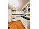 Bright kitchen with white cabinets, a white oven and hardwood floors at 1829 Cypress Point Ln, Sarasota, FL 34234
