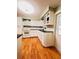 Bright kitchen with white cabinets, a white oven and hardwood floors at 1829 Cypress Point Ln, Sarasota, FL 34234