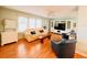 Bright living room with hardwood floors, ceiling fan, light green walls and large TV at 1829 Cypress Point Ln, Sarasota, FL 34234
