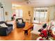 Open living room with hardwood floors, light green walls, and stylish furnishings at 1829 Cypress Point Ln, Sarasota, FL 34234