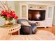 Inviting living room featuring a large entertainment center, comfortable seating and stylish accents at 1829 Cypress Point Ln, Sarasota, FL 34234