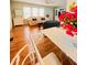 Bright living room with hardwood floors, ceiling fan, light green walls and large TV at 1829 Cypress Point Ln, Sarasota, FL 34234