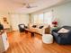 Bright living room with hardwood floors, ceiling fan, light green walls and stylish furnishings at 1829 Cypress Point Ln, Sarasota, FL 34234