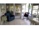 Inviting sunroom featuring a tile floor and comfortable seating to enjoy the lush tropical views at 1829 Cypress Point Ln, Sarasota, FL 34234