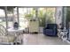 Light-filled sunroom featuring seating, a tile floor, and lush tropical views at 1829 Cypress Point Ln, Sarasota, FL 34234