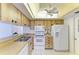Well-lit kitchen with bright white appliances and ample counter space for all your cooking needs at 1906 70Th W St, Bradenton, FL 34209