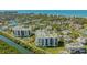 Aerial view of condo community on waterfront with lush landscaping and water views at 1932 Harbourside Dr # 217, Longboat Key, FL 34228
