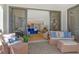 Charming balcony with tile floor and stylish wicker furniture extending to a cozy living area at 1932 Harbourside Dr # 217, Longboat Key, FL 34228