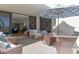Relaxing covered patio featuring tile floor and wicker furniture with an open view to the living room at 1932 Harbourside Dr # 217, Longboat Key, FL 34228