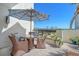 Inviting outdoor seating area with comfortable wicker furniture and a shade umbrella overlooking a garden at 1932 Harbourside Dr # 217, Longboat Key, FL 34228
