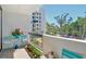 Balcony with tiled floors, views of the building and surrounding greenery at 1932 Harbourside Dr # 217, Longboat Key, FL 34228
