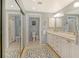 Bathroom with double vanity, large mirror, and separate toilet and shower rooms at 1932 Harbourside Dr # 217, Longboat Key, FL 34228