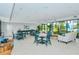Bright community clubhouse featuring ample seating, tables, and views to the outdoors at 1932 Harbourside Dr # 217, Longboat Key, FL 34228