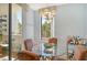 Bright dining area with round glass table, four chairs, and an elegant chandelier at 1932 Harbourside Dr # 217, Longboat Key, FL 34228