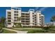 Well-maintained condo building with tropical landscaping and manicured lawn at 1932 Harbourside Dr # 217, Longboat Key, FL 34228