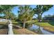 A tranquil backyard with a small stream running through it, offering a peaceful view at 2385 Tall Oak Ct, Sarasota, FL 34232