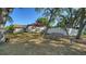 Spacious backyard featuring a wooden swing and a privacy fence at 2385 Tall Oak Ct, Sarasota, FL 34232