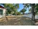 A large, fenced backyard with mature trees and plenty of space for outdoor activities at 2385 Tall Oak Ct, Sarasota, FL 34232