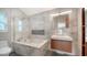 Modern bathroom with marble tiling, glass shower, floating vanity, and ample natural light at 2385 Tall Oak Ct, Sarasota, FL 34232