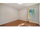 The bedroom is well-lit with hardwood flooring and a large window bringing in natural light at 2385 Tall Oak Ct, Sarasota, FL 34232