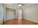 An open closet and doorway define this bedroom featuring wood floors and neutral wall paint at 2385 Tall Oak Ct, Sarasota, FL 34232
