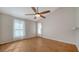 Large bedroom with hardwood floors, fan, and natural lighting at 2385 Tall Oak Ct, Sarasota, FL 34232