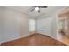 A bright bedroom with wood flooring, a double door closet, and a window with patterned curtains at 2385 Tall Oak Ct, Sarasota, FL 34232