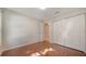 This bedroom features wood floors, and a large closet for storage at 2385 Tall Oak Ct, Sarasota, FL 34232