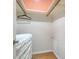 Walk-in closet with a skylight, storage space, and wood laminate flooring at 2385 Tall Oak Ct, Sarasota, FL 34232