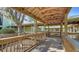 Charming covered walkway featuring wooden beams and a clear view of the lush surroundings and trees at 2385 Tall Oak Ct, Sarasota, FL 34232
