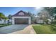 Attractive home with a two-car garage, manicured lawn, and a well-maintained driveway at 2385 Tall Oak Ct, Sarasota, FL 34232