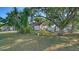 Beautiful house with well-maintained lawn, lush trees, and a fenced backyard at 2385 Tall Oak Ct, Sarasota, FL 34232