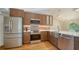 Renovated kitchen with stainless steel appliances, tile backsplash, and custom cabinets at 2385 Tall Oak Ct, Sarasota, FL 34232