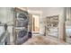 Well-organized laundry area with a stacked washer and dryer, shelving, and easy access to the outdoors at 2385 Tall Oak Ct, Sarasota, FL 34232