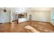 Spacious open-concept living area featuring hardwood floors and modern lighting fixtures at 2385 Tall Oak Ct, Sarasota, FL 34232
