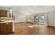 Open-concept living room with wood floors, high ceilings, and abundant natural light at 2385 Tall Oak Ct, Sarasota, FL 34232