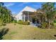 Landscaped yard surrounding this home with lanai and lush greenery at 3390 Yonge Ave # 41, Sarasota, FL 34235