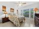 Bedroom with large windows, ceiling fan, and neutral paint with two side tables and matching lamps at 3390 Yonge Ave # 41, Sarasota, FL 34235