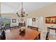 Dining space featuring tile flooring, a chandelier and views to the living space at 3390 Yonge Ave # 41, Sarasota, FL 34235