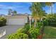 A well-kept home with lush, colorful landscaping, a lamp post, and an attached two-car garage at 3390 Yonge Ave # 41, Sarasota, FL 34235