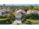 A charming home featuring lush landscaping, mature palm trees, and a well-maintained lawn at 3390 Yonge Ave # 41, Sarasota, FL 34235