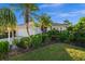 A cozy home with mature landscaping, palm trees, and a well-manicured lawn at 3390 Yonge Ave # 41, Sarasota, FL 34235
