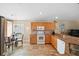 Well-lit kitchen features wooden cabinets, granite countertops, modern appliances, and a cozy breakfast nook at 3390 Yonge Ave # 41, Sarasota, FL 34235
